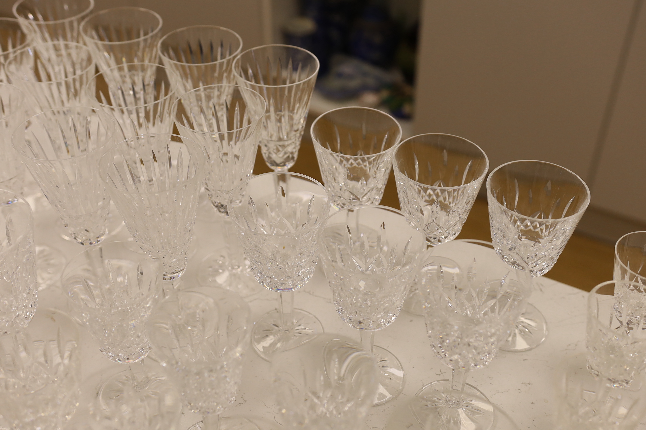 A 68 piece part suite of Waterford cut crystal ‘’Lismore’’ pattern drinking glassware, consisting:- 12 champagne glasses, 9 red wine glasses, 6 white wine glasses, 12 liqueur glasses, 12 whisky tumblers, 12 sherry glasse